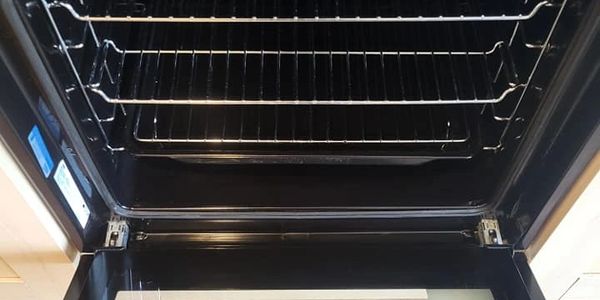 open oven with silver racks. shiny. oven clean. deep cleaning. deep clean. end of tenancy cleaning.