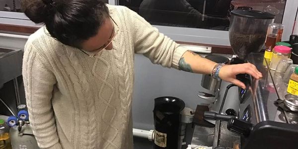 person using a coffee machine