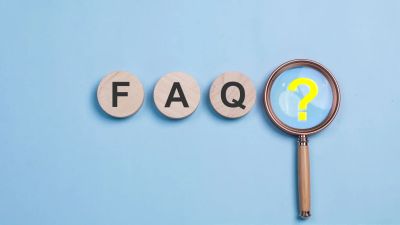 FAQ with magnifying glass highlighting question mark.