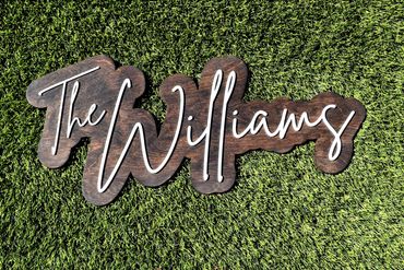 A backdrop family name sign made with wood and acrylic available in multiple stains and sizes.
