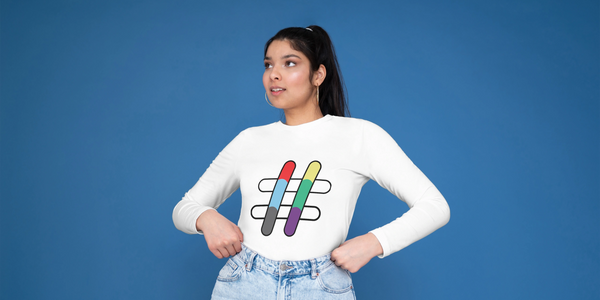 A young woman stands with her hands on her hips, she is wearing a top with the IMatter hashtag icon.
