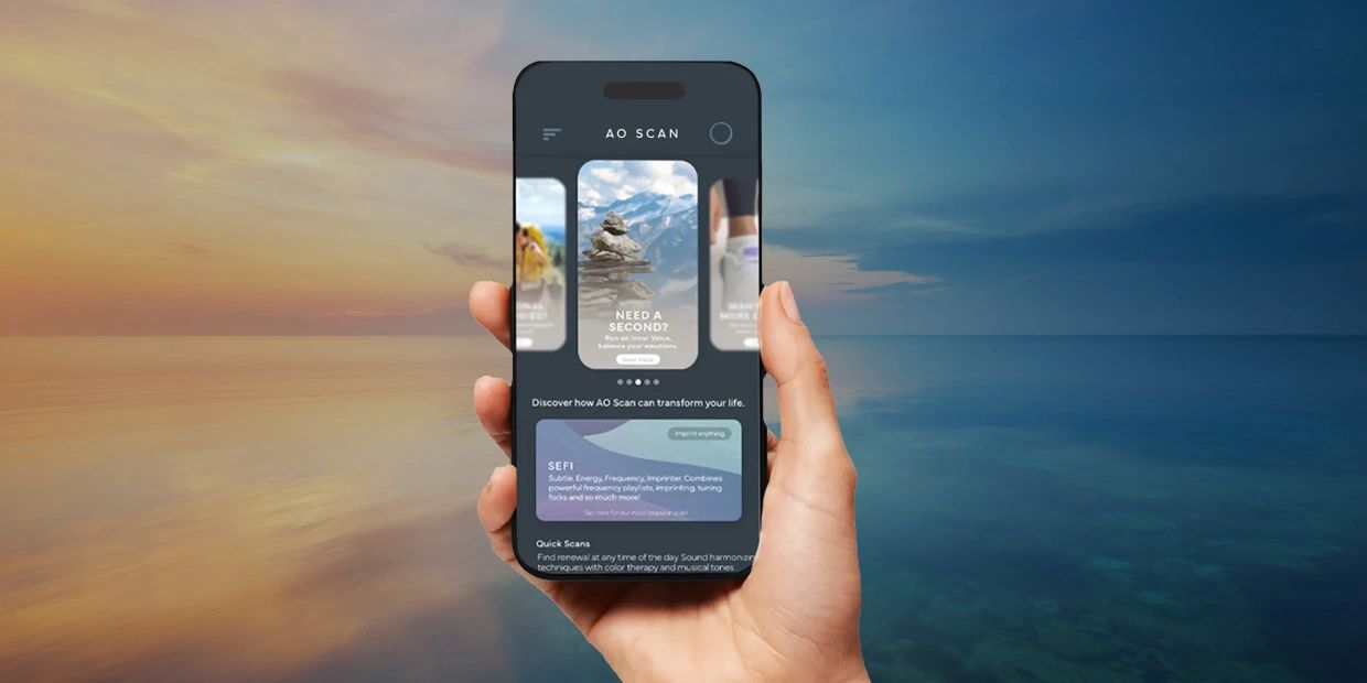 Hand holding smartphone with AO Scan app at sunset over ocean.