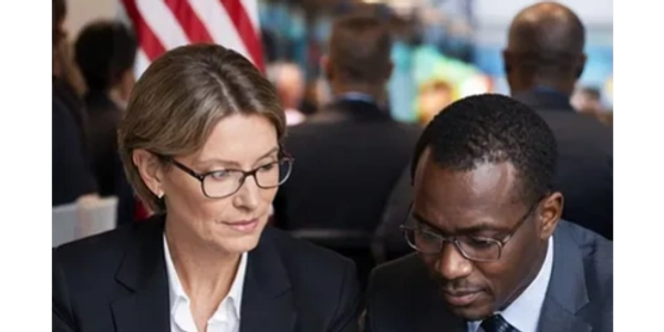 Two professionals discussing work in a formal setting.