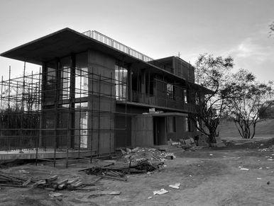 Unfinished concrete building with scaffolding.