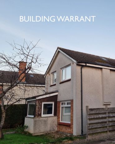 A two-story house with "BUILDING WARRANT" text above.
