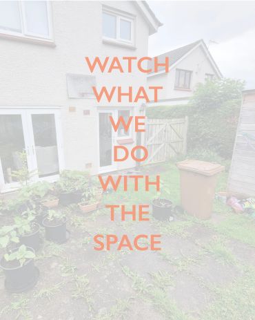 Backyard with potted plants and a trash bin.