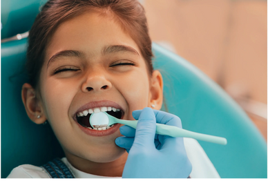 a little girl smiling at dentist