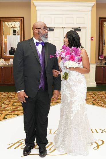 Bride and man in formal attire sharing a moment.