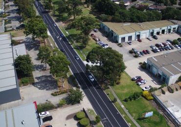 Aerial view of a road through an industrial area.