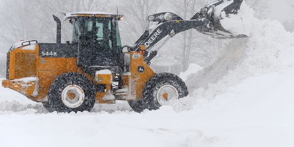 Loader piling snow