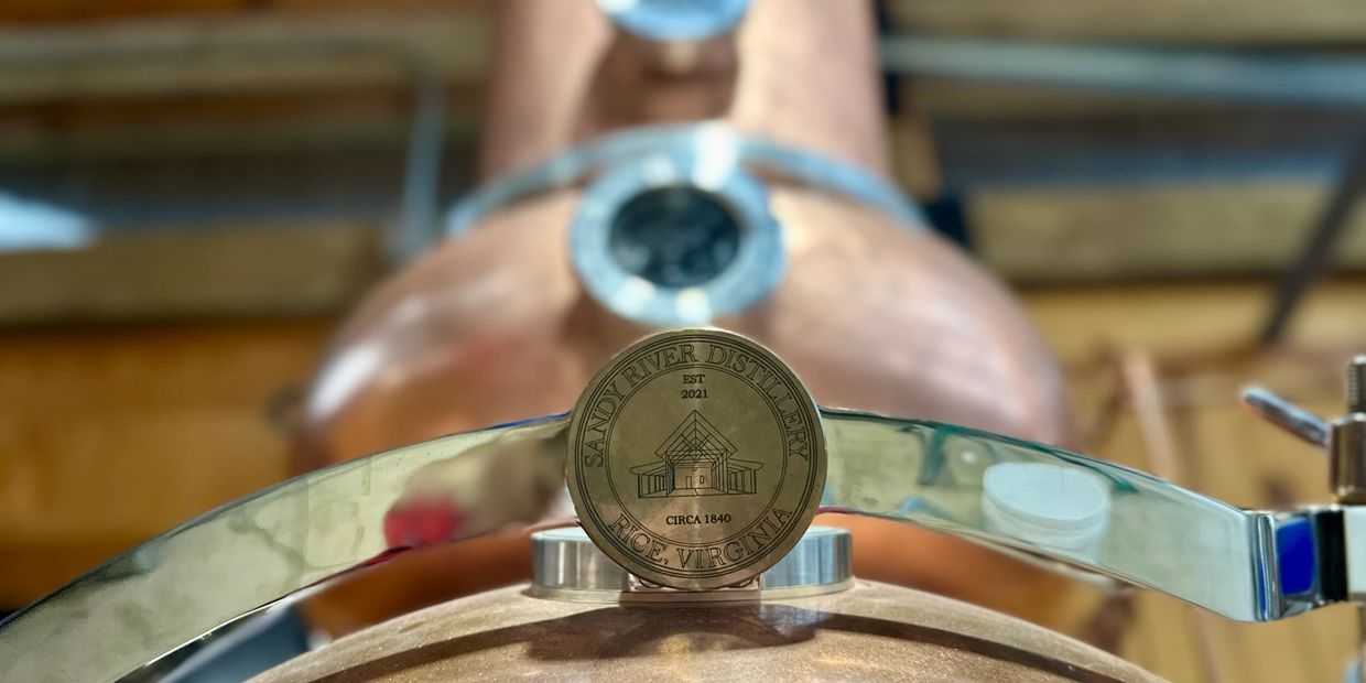 Close-up of a medallion on a copper distillery apparatus at Sandy River Distillery.