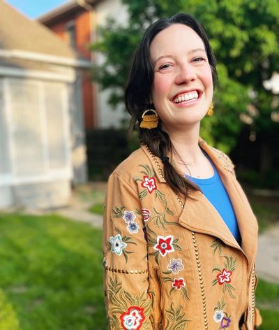 Woman smiling outside.