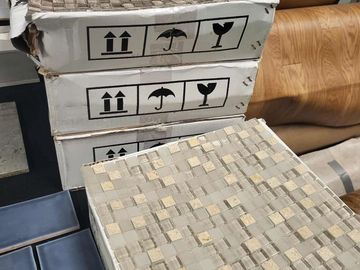 backsplash tile laid on top of the box for display