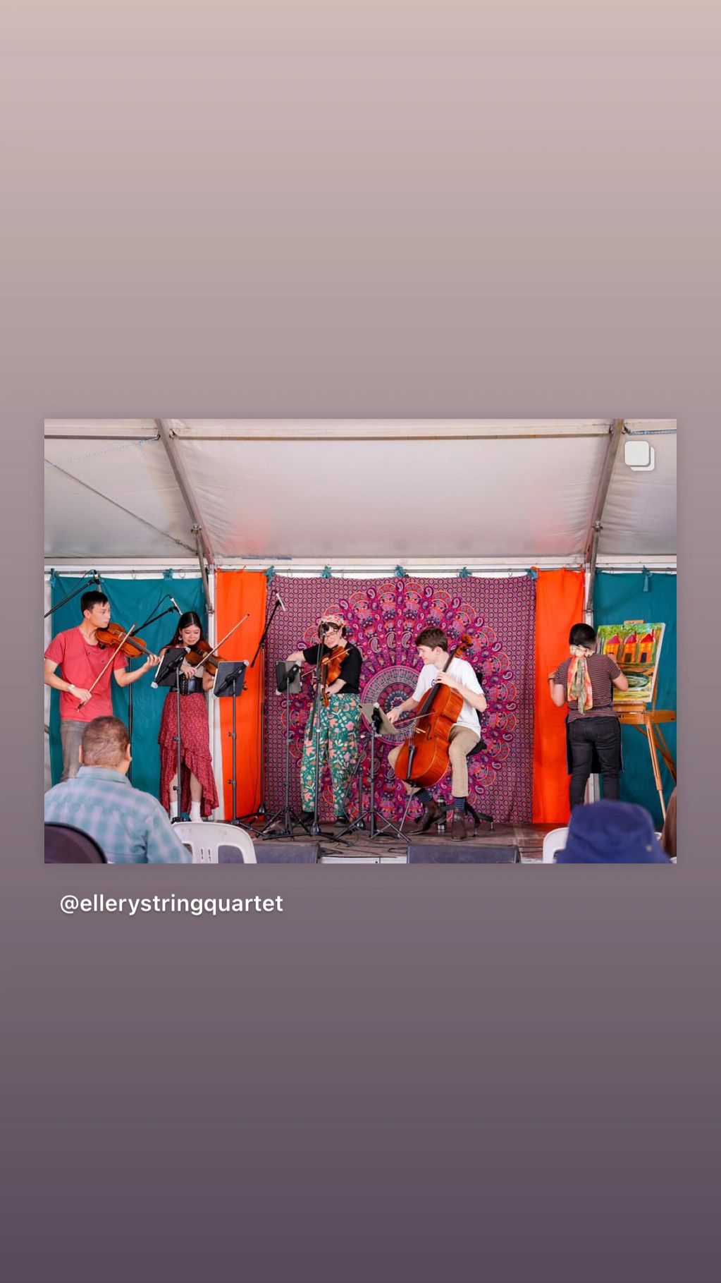 A group og musicians playing and an artist painting on stage.