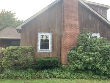 side of the house view two windows on other side of the chimney