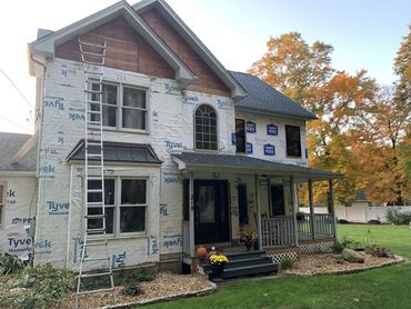 removed old wood and first wrapped the house, before siding can be installed