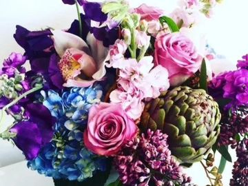 Colorful flower bouquet with roses and an artichoke.