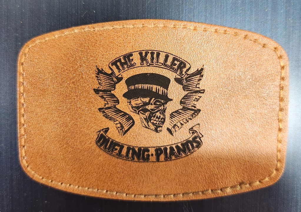 Leather patch with a skull wearing a hat and 'The Killer Dueling Pianos' text.