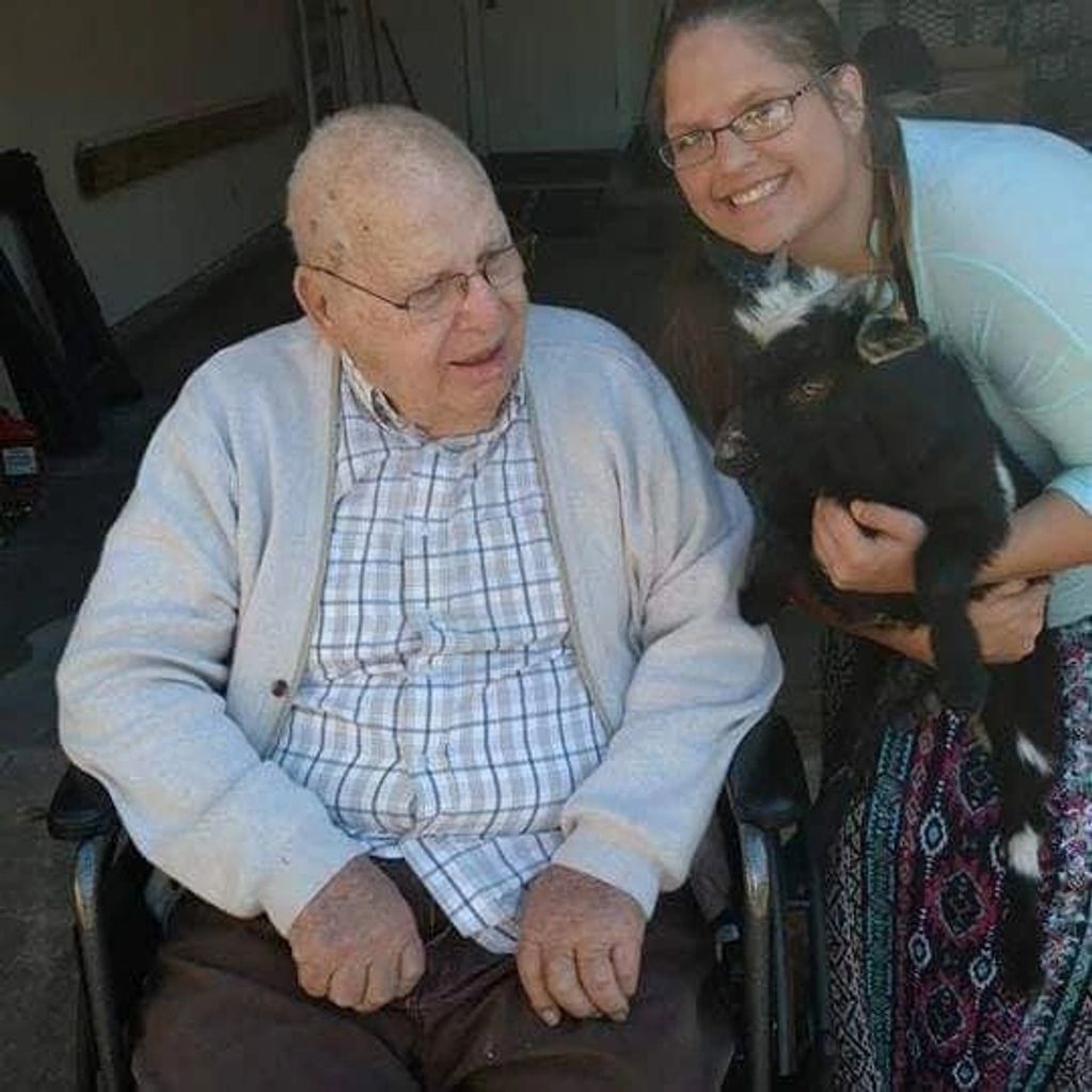 Ruben enjoying seeing a little goat that was brought to his nursing home.