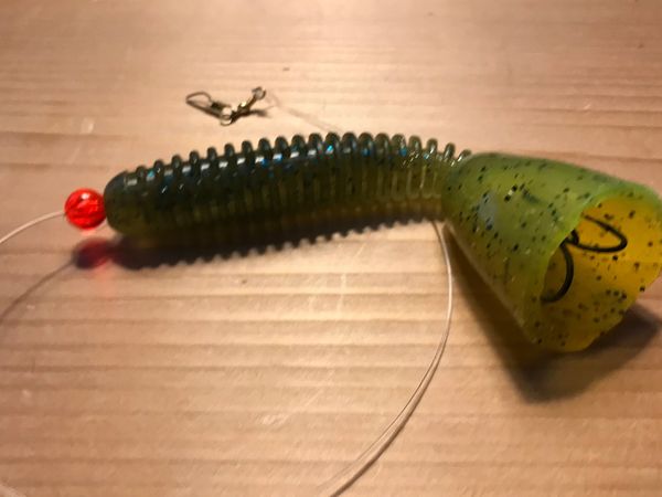 A weedless treble hook with a green lure