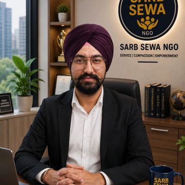Man in a turban sitting confidently in an office of Sarb Sewa NGO.