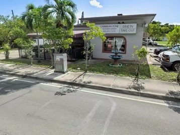 Caribbean Zone restaurant with outdoor fountain and palm trees.