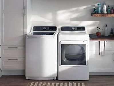 Midea 4.5 cu. ft. white top load washer and a Midea 7.5 cu. ft. white front load electric dryer 