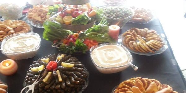 A table set with various dishes and appetizers for a gathering.