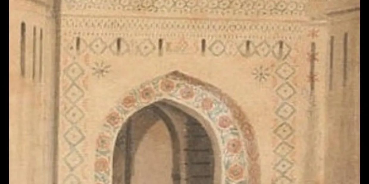 Historic arched gateway with intricate floral patterns and people nearby.