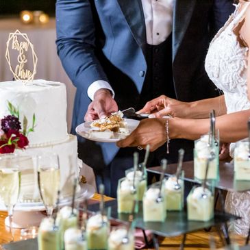 Bride and groom cutting their wedding cake together.
