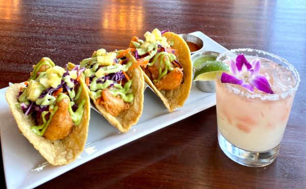 Beer battered fried fish garnished with mango pineapple pico de gallo crispy cabbage, and chipotle m