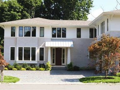 Front yard idea with Maple trees and paved driveway with cobblestone and peastones for drainage