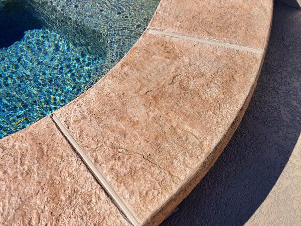 Decorative concrete Arizona pool deck with pool in background