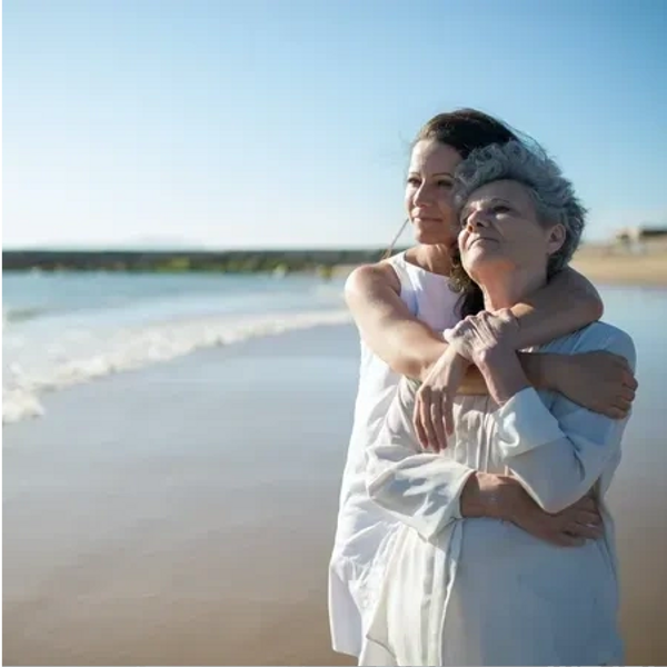 mother and daughter hugging at beach