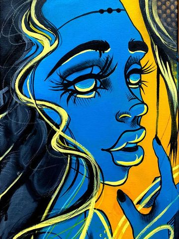 Colorful street art of a blue face with long eyelashes.
