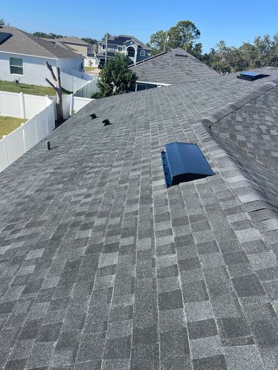 Newly installed gray asphalt shingle roof on a residential home.