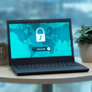 Laptop screen showing a secured lock icon with a world map background.