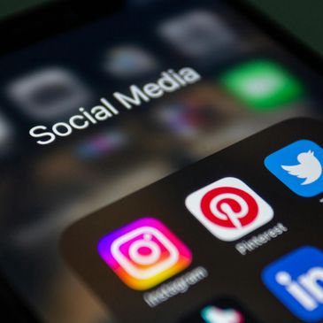 Close-up of a phone screen showing social media app icons.