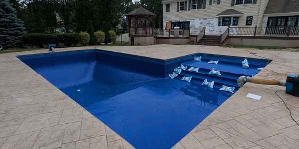 new liner and pool deck with sunledge and stadium steps
