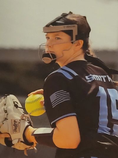 focused girl throwing a softball