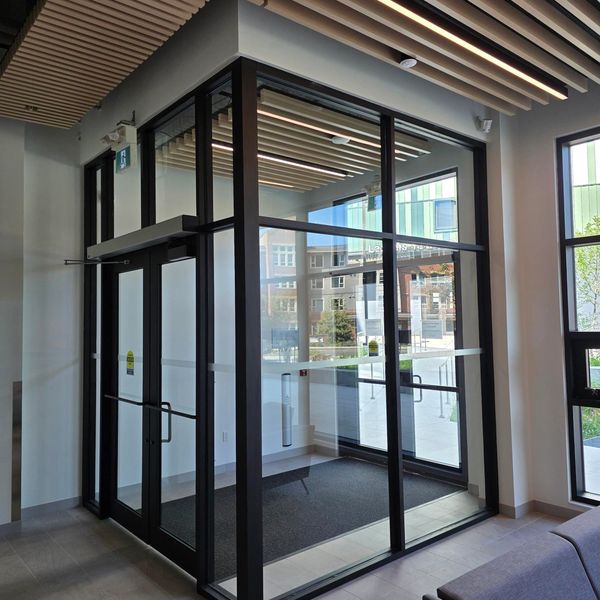 Modern glass door entrance inside a building.