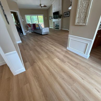 Spacious living room with wood flooring and neutral tones.
