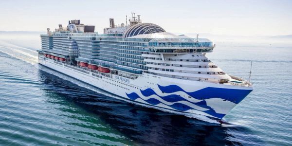 Large white cruise ship sailing in calm waters.
