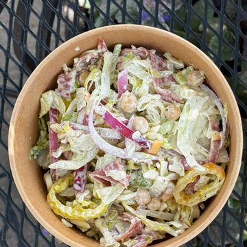 Fresh salad with lettuce, onions, and chickpeas in a bowl.