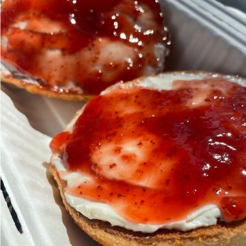 Bagels with cream cheese and strawberry jam.