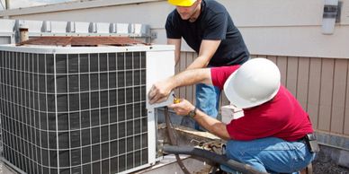 repairmen on roof fixing air conditioner unit while properly insured with air conditioning contr