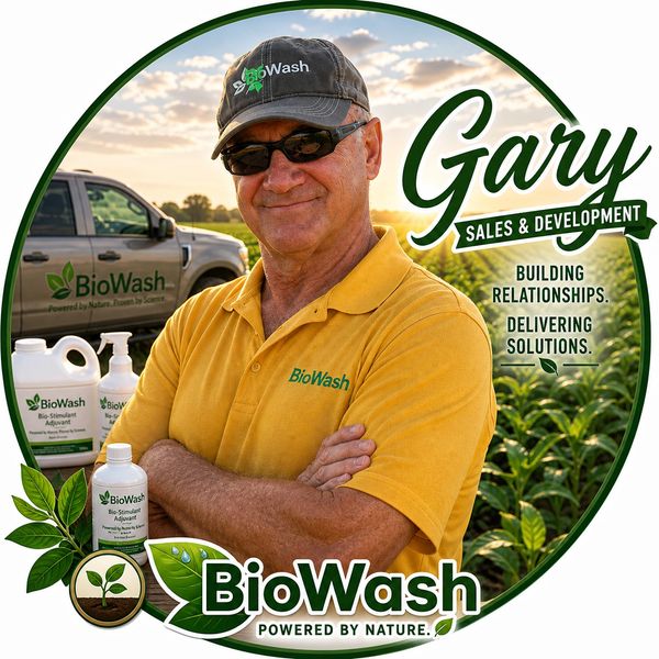 Gary from BioWash stands confidently in a field with product bottles and company truck.