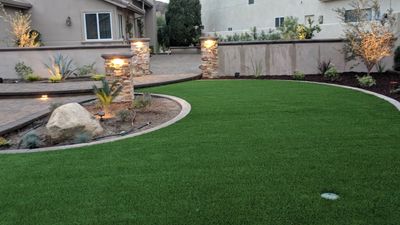 Curved artificial turf with Pathway to the front Courtyard at dusk