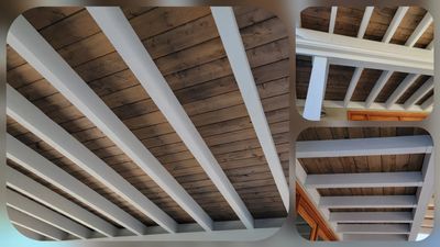 Wooden ceiling with white beams in a cozy interior space.
