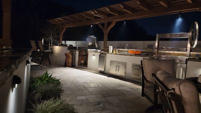 Custom outdoor bar and culinary oasis with a wood pergola built by Royal Design Builders in Riversid